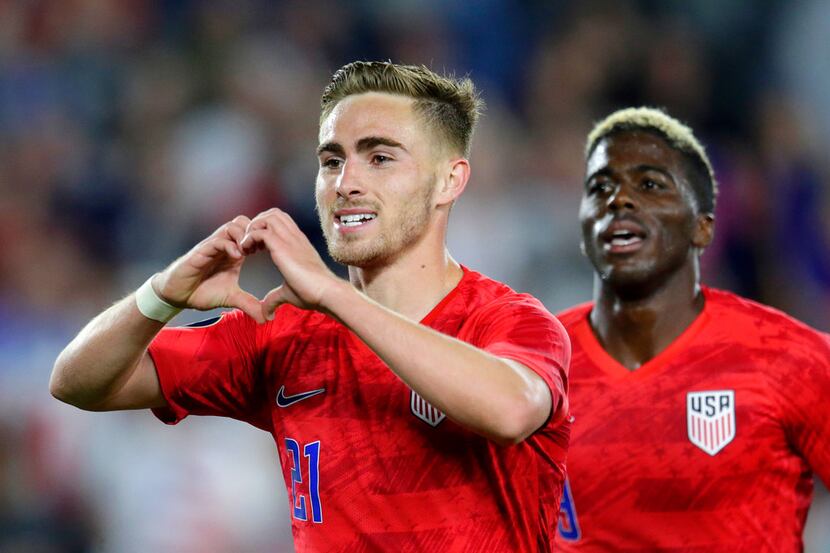 United States' Tyler Boyd, left, celebrates his goal against Guyana with fans as teammate...