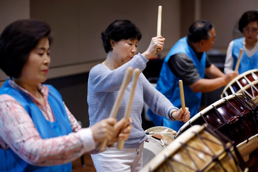 Korean elders who are members of Arirang Texas Group beat on the buk at the Carrollton...