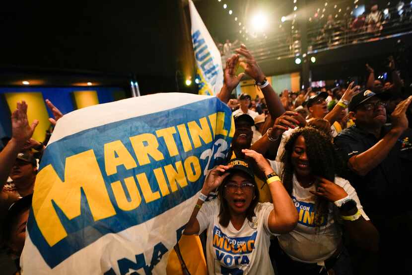 Supporters of presidential candidate José Raúl Mulino celebrate early results after the...