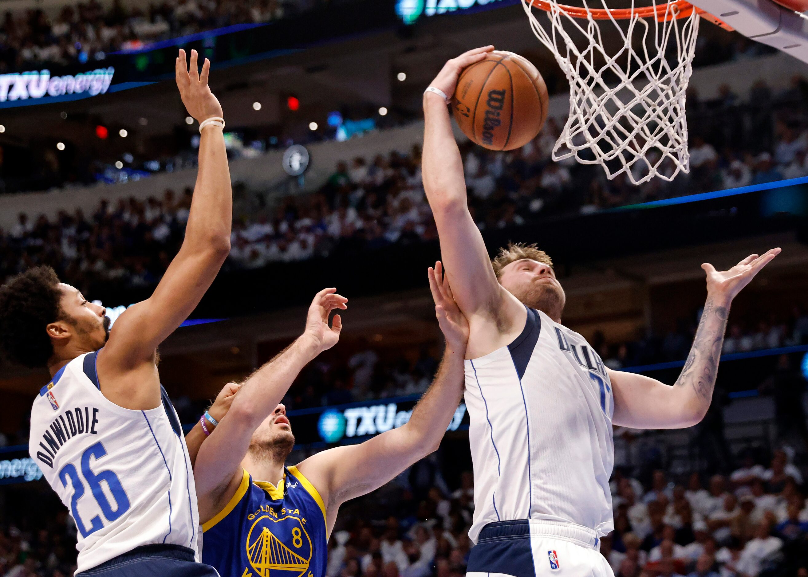 Dallas Mavericks guard Luka Doncic (77) pulls down a defensive rebound against Golden State...