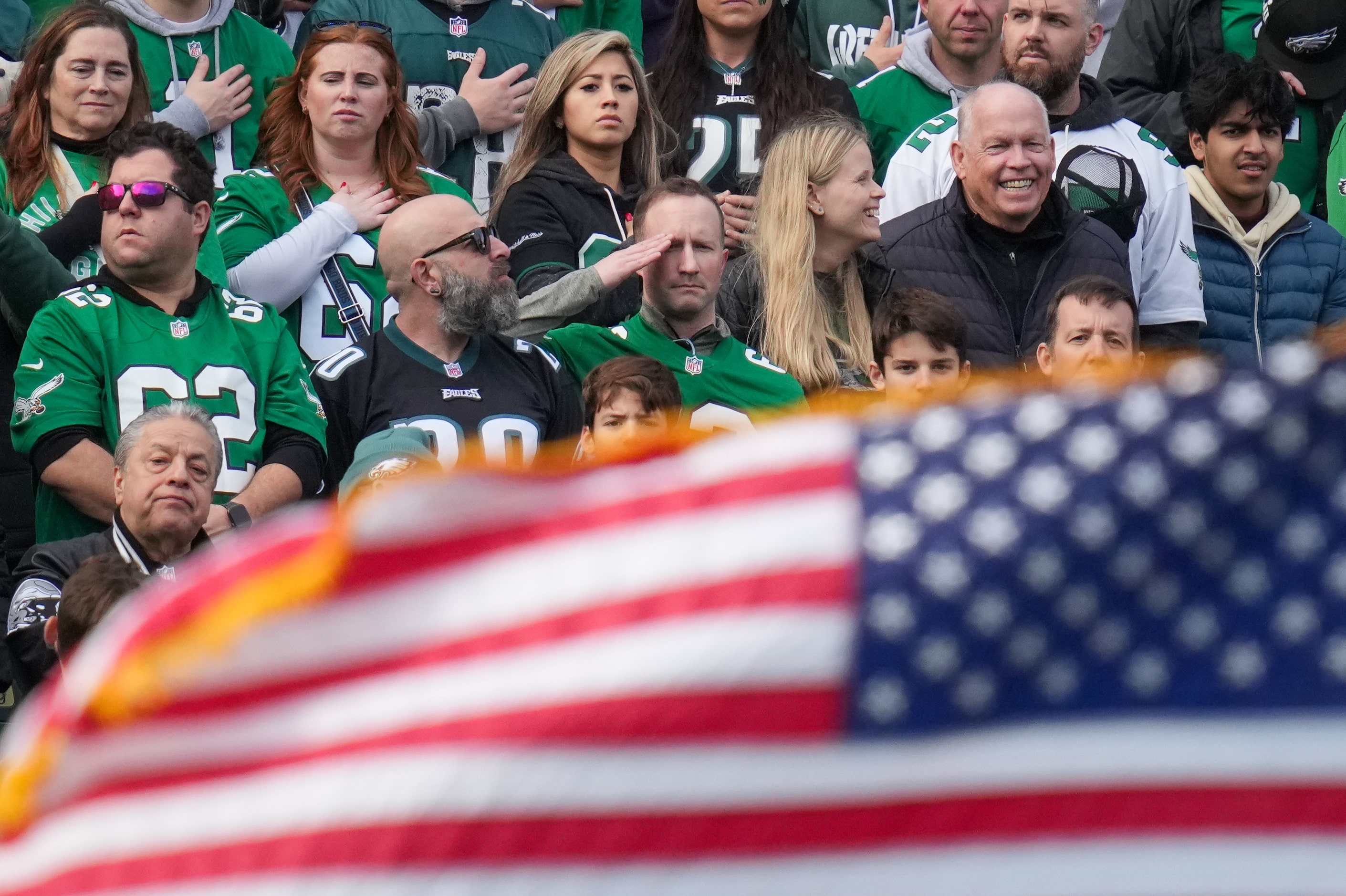 Fans stand for the national anthem before an NFL football game between the Dallas Cowboys...