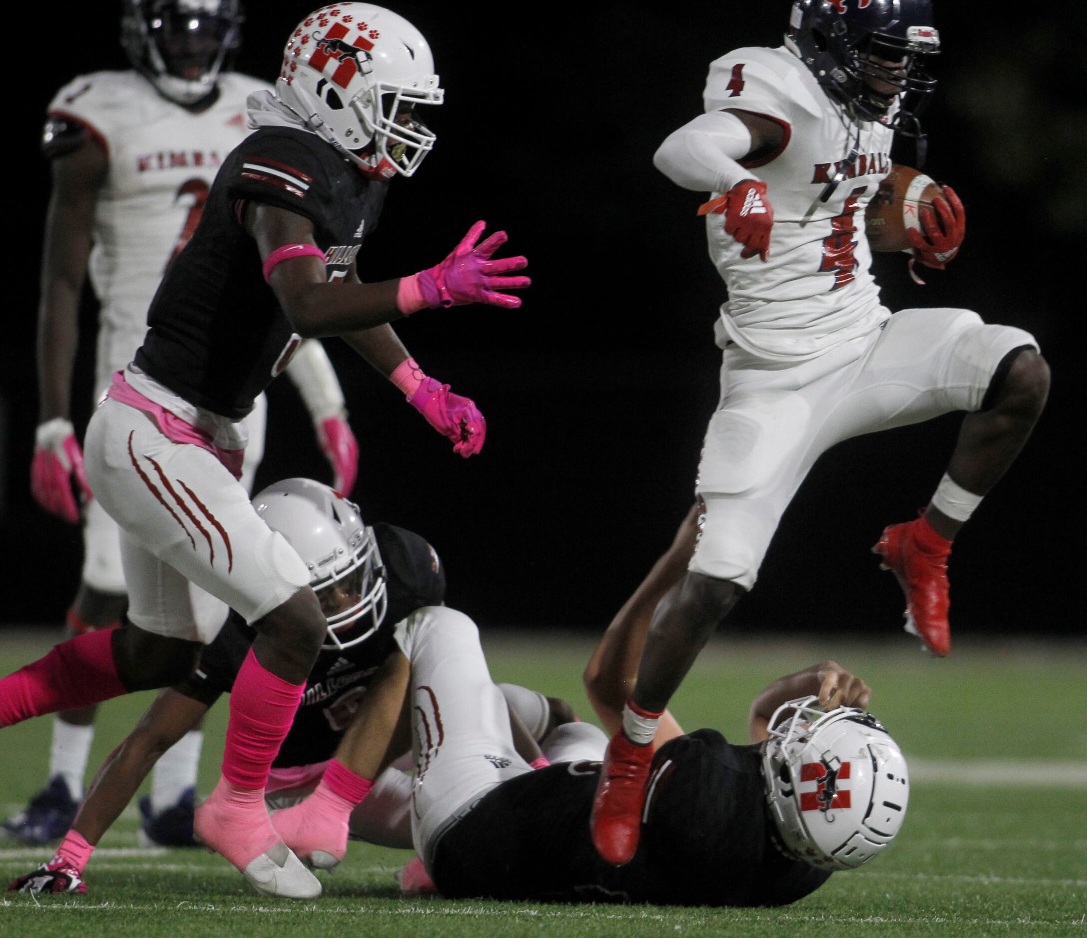 Dallas Kimball running back Niteroi Davis (4) leaps from an attempted tackle by an...
