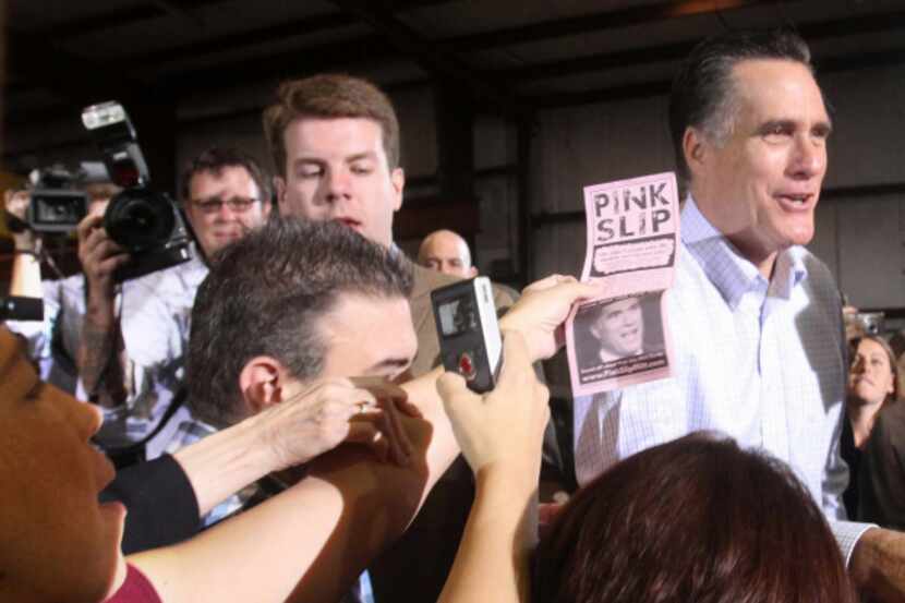 A Democratic activist tried to hand a "pink slip" to Republican presidential candidate Mitt...