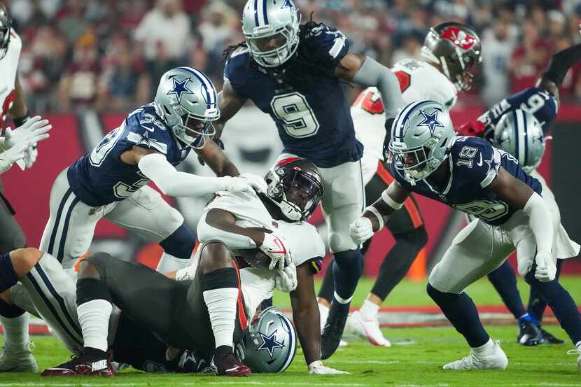 Tampa Bay Buccaneers running back Leonard Fournette (7) is brought down by Dallas Cowboys...