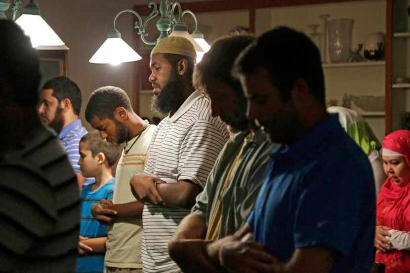 
Daniel Abebe (center) joins other Muslims in prayer before a nightly iftar dinner at...
