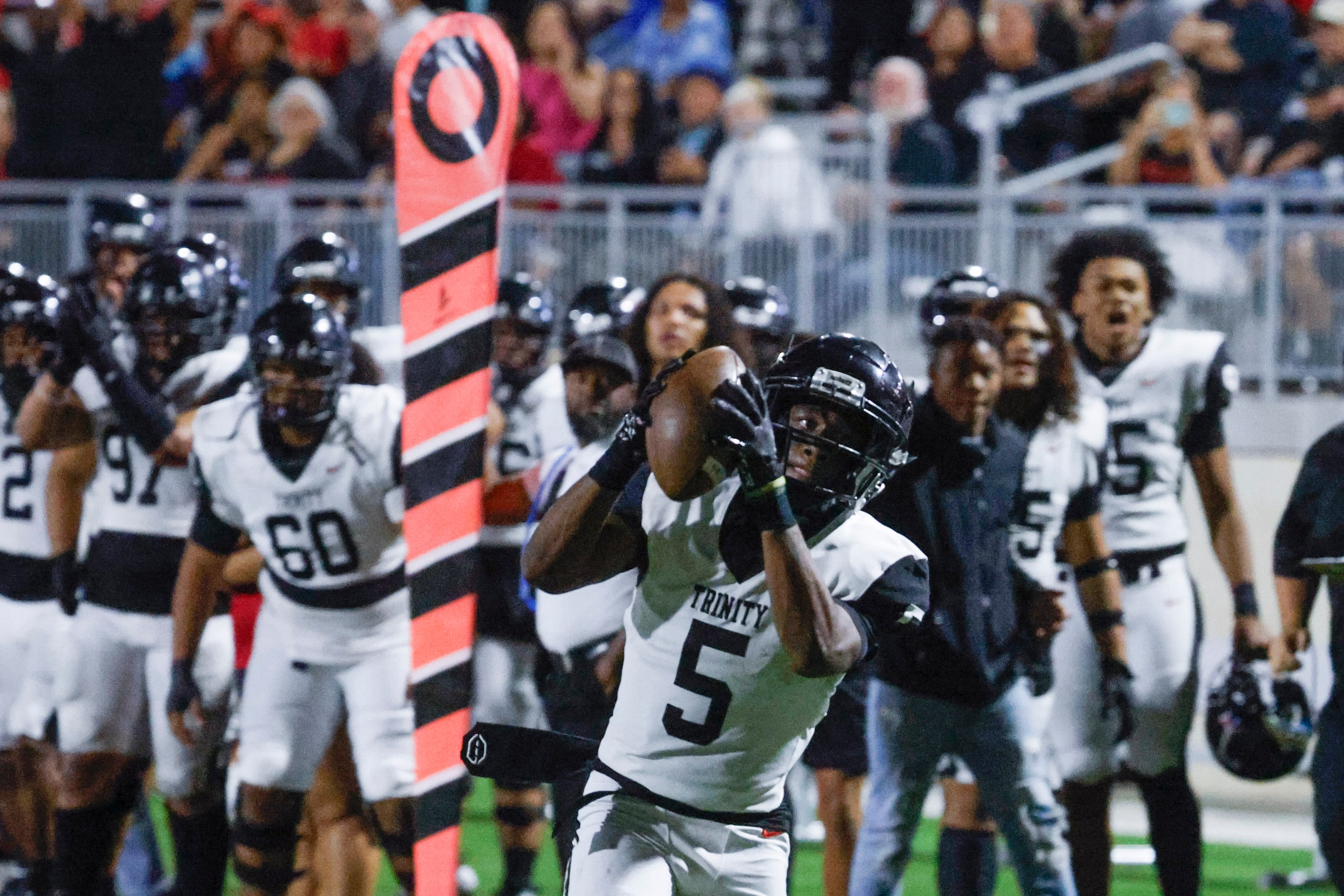 Trinity High’s Ethan Wright scores a touchdown against Crowley High during the first half of...