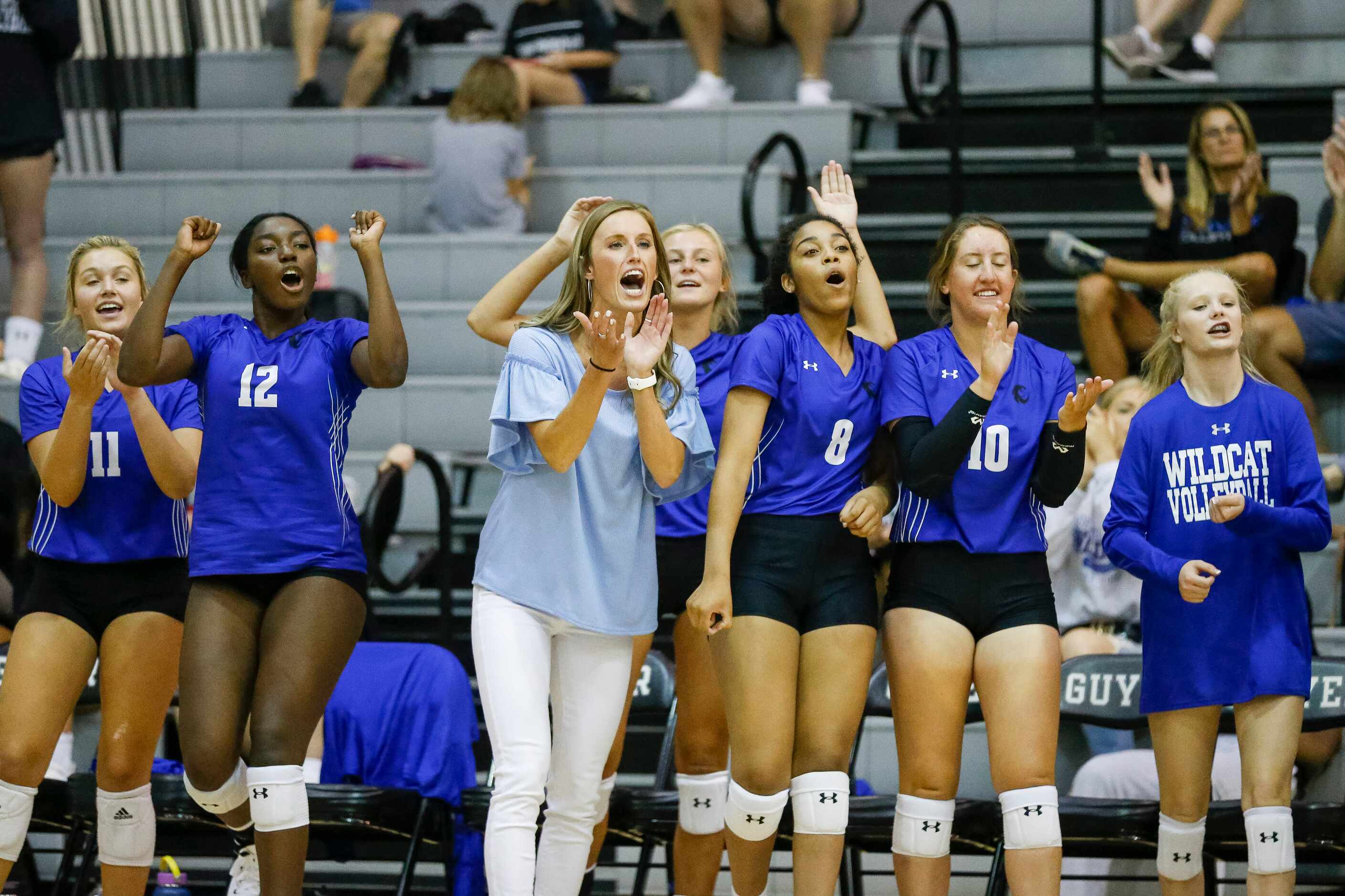 Denton Guyer head coach Leslie Jackson and the bench react after a point during the second...