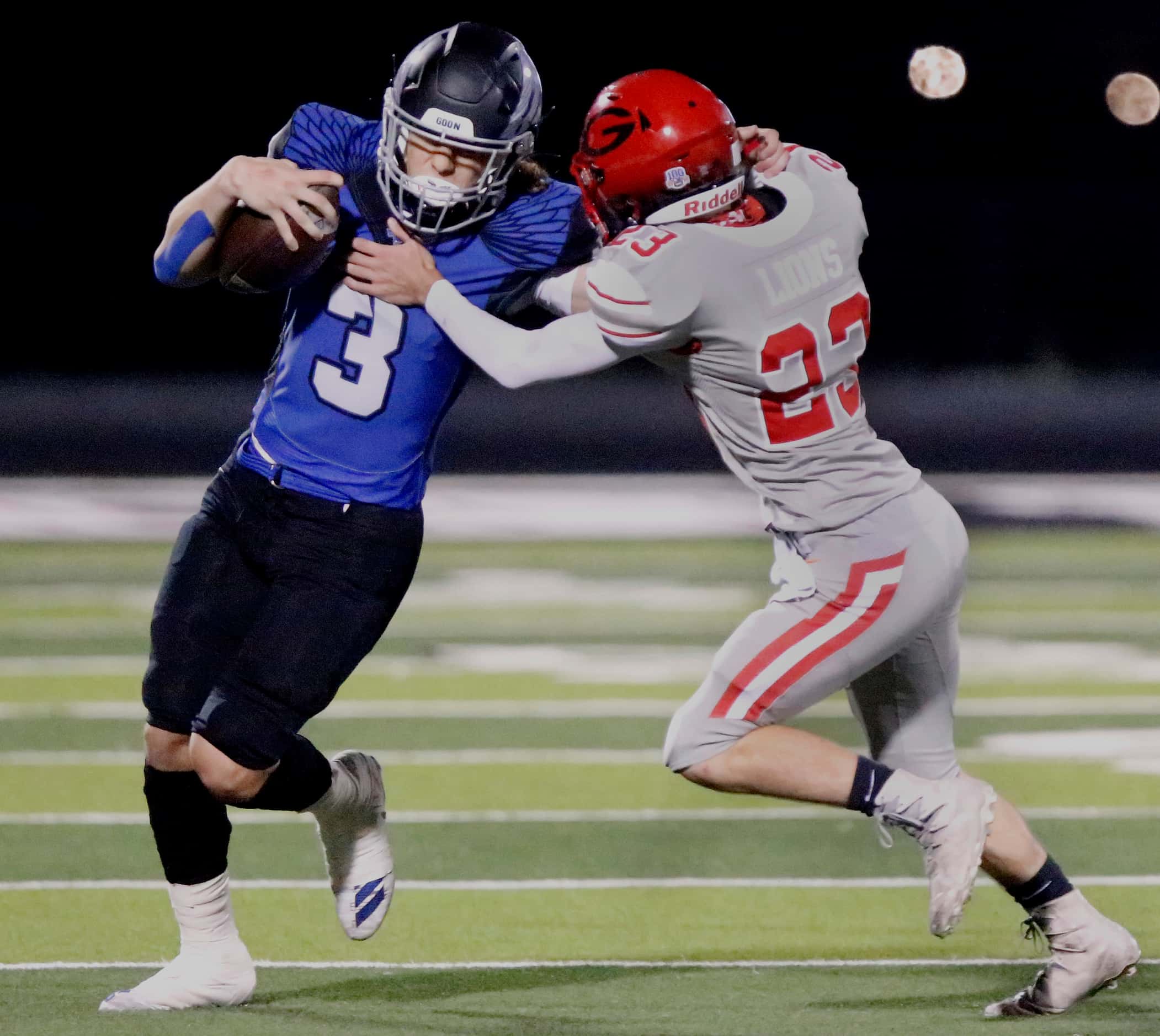 North Forney High School quarterback Jacob Acuna (3) is met by Greenville High School safety...