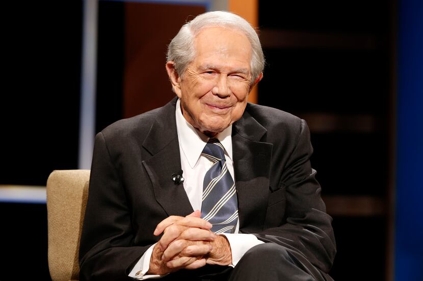 FILE - Rev. Pat Robertson poses a question to a Republican presidential candidate during a...