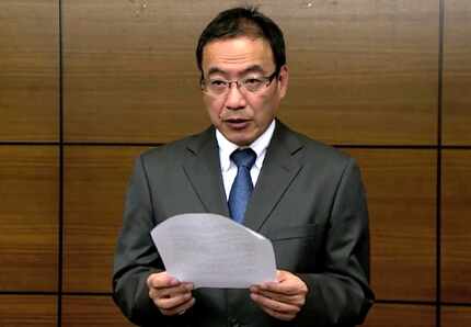 Hsinchu Kuang Fu High School Principal Cheng Hsiao-ming reads an apology to the media in...