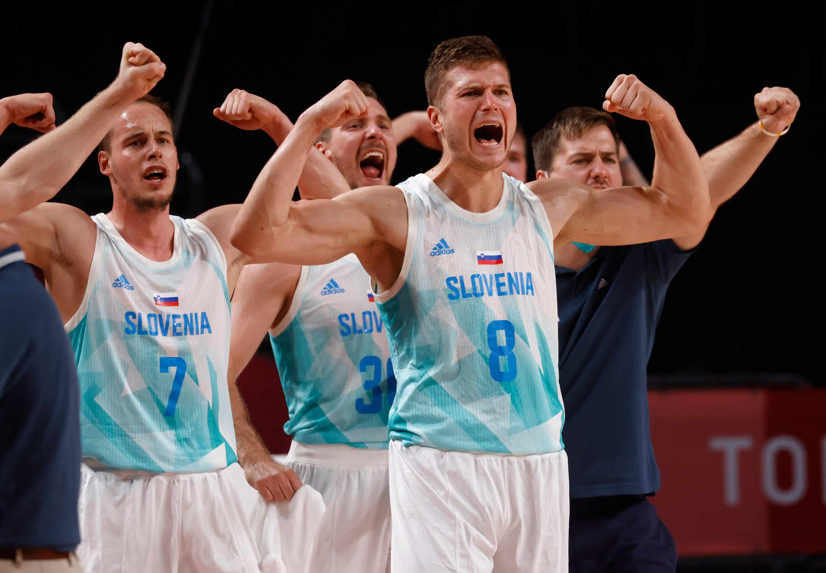 Slovenia’s Edo Muric (8), Klemen Prepelic (7) and teammates celebrate after Mike Tobey (10)...