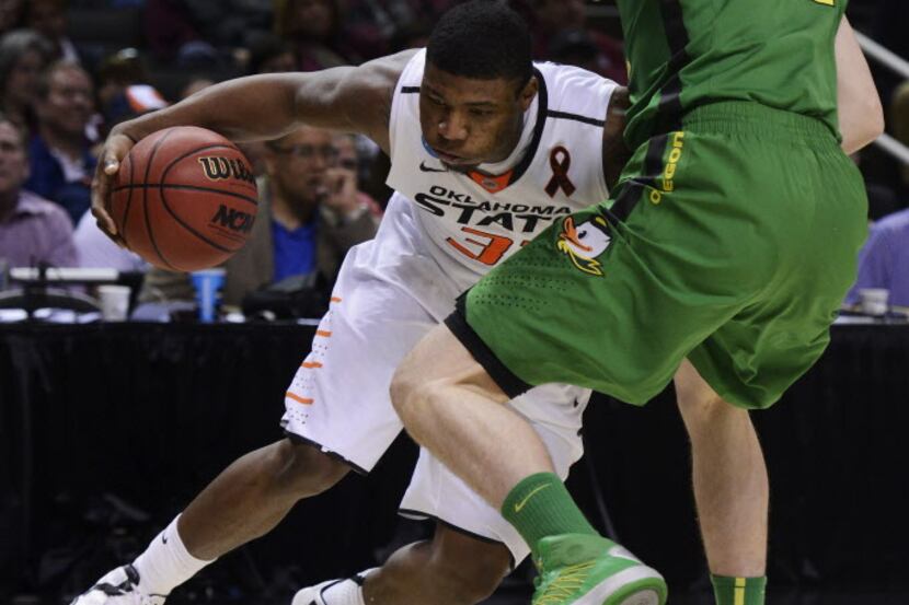 SAN JOSE, CA - MARCH 21:  Ben Carter #32 of the Oregon Ducks fouls Marcus Smart #33 of the...