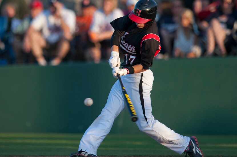 Heath's Bret Boswell hits and RBI triple against Wakeland during the 4A Region II final at...