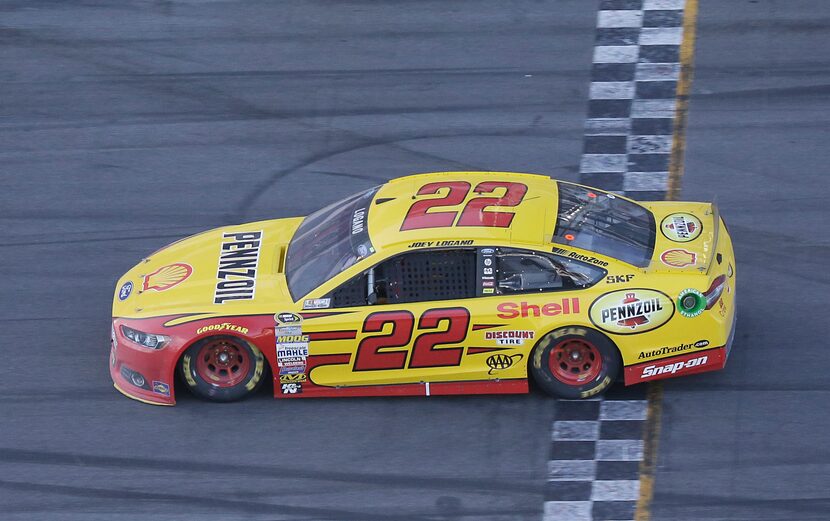 Joey Logano crosses the finish line to win the Daytona 500 NASCAR Sprint Cup series auto...