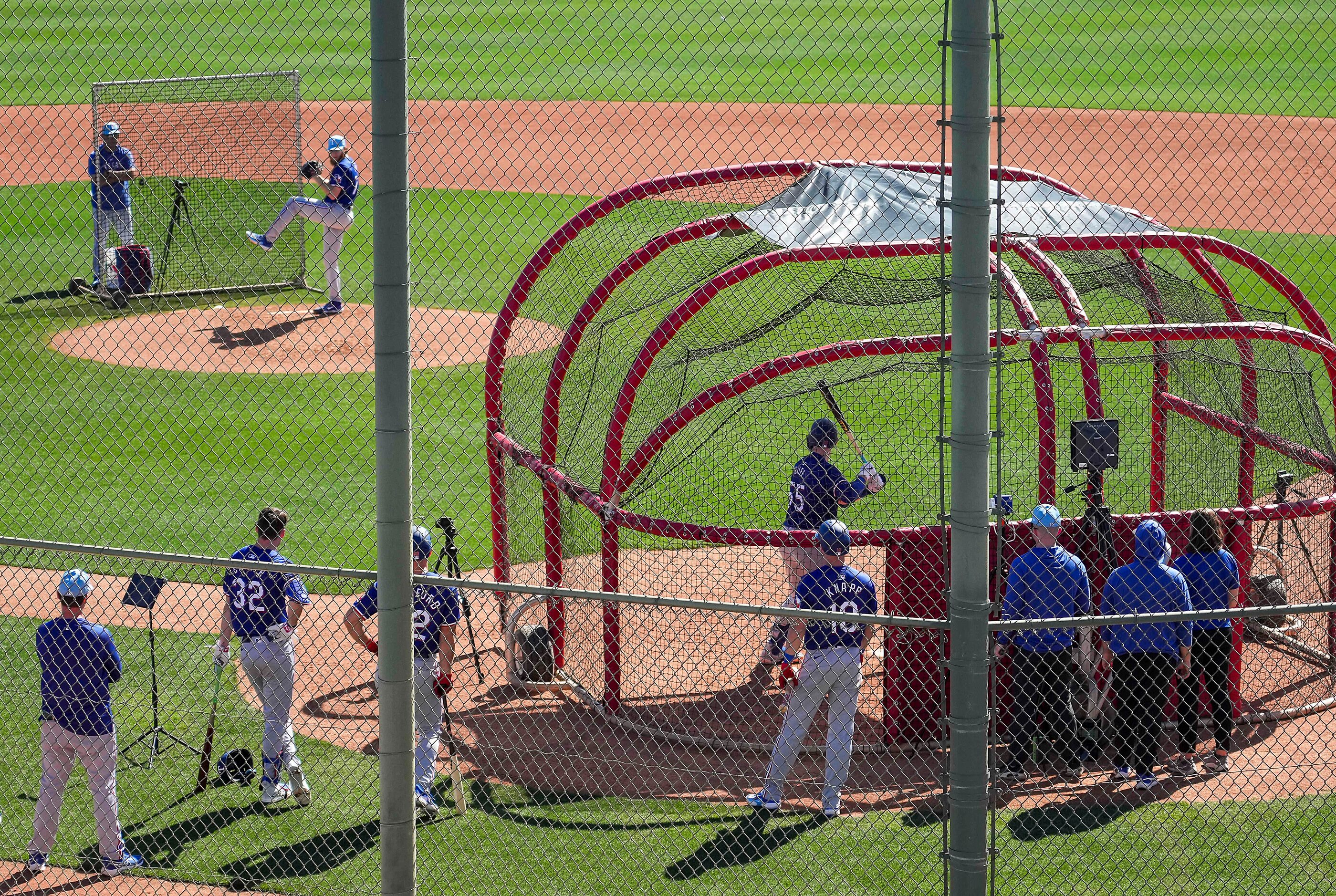 Texas Rangers catcher Sam Huff (55) faces pitcher Zak Kent in live batting practice during...