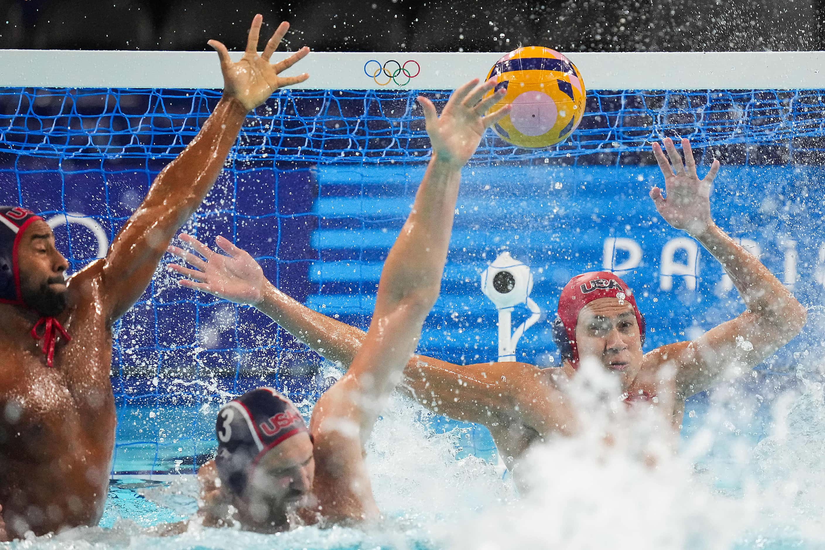 Goalkeeper  Adrian Weinberg, Max Irving (12) and Marko Vavic (3) of the United States defend...