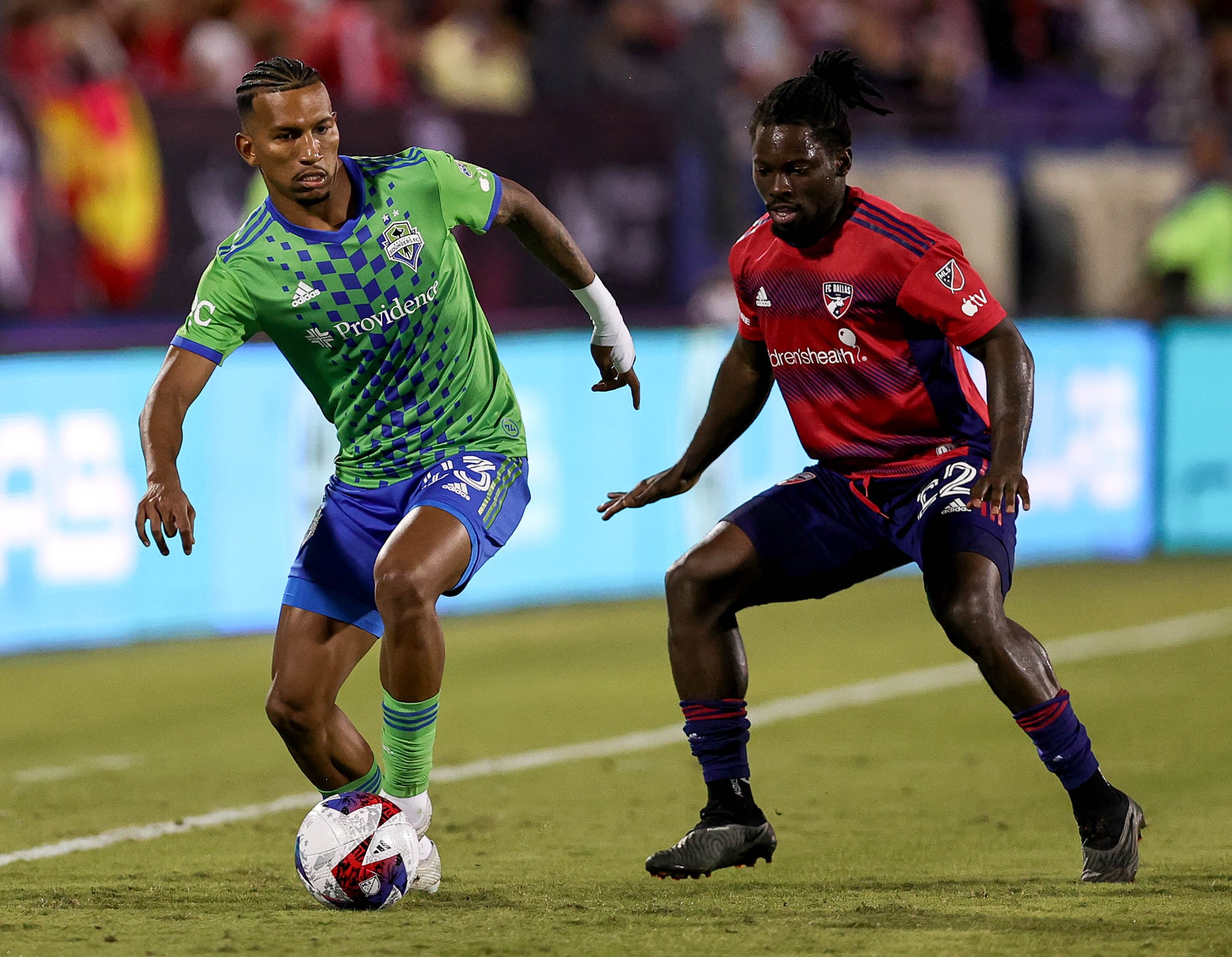 Seattle midfielder Leo Chu (23) tries to control the ball against FC Dallas defender Ema...