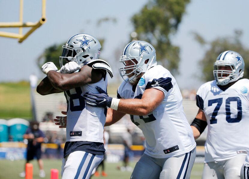 Dallas Cowboys wide receiver Dez Bryant (88) throws up an "X," after making a one handed...