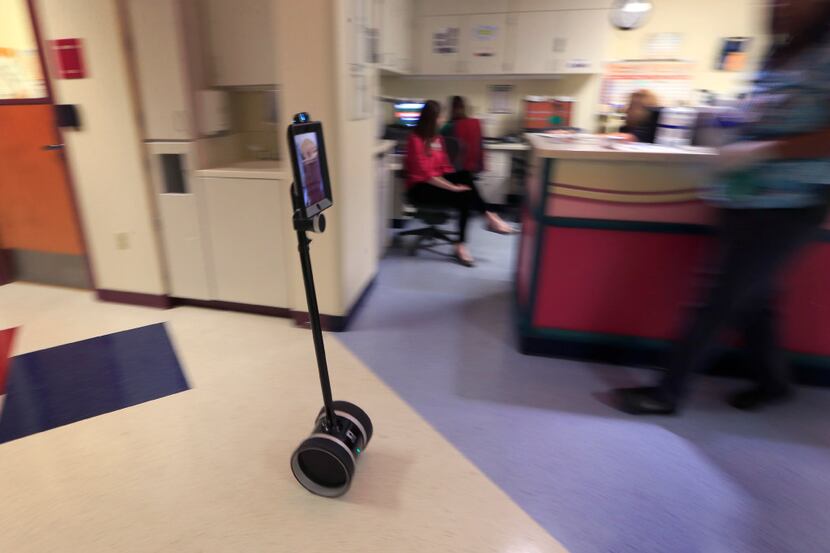 A patient-operated robot named REX roams the hallways at Children's Mercy Hospital in Kansas...