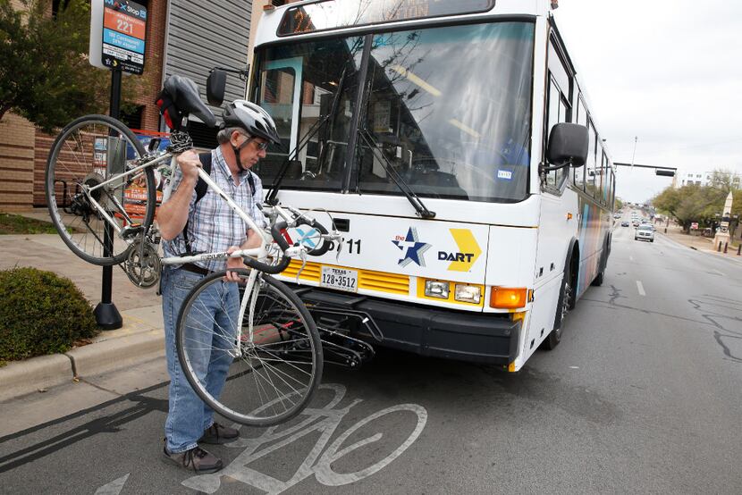 An Arlington MAX bus picks up John Smith and his bicycle at the College Park stop in...