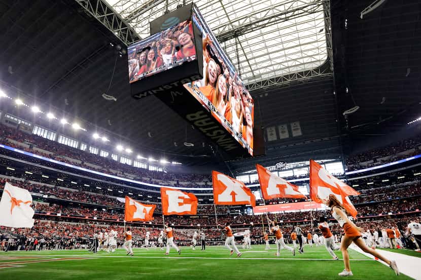 The Texas Longhorns spirit squad carries the school colors following a first half touchdown...