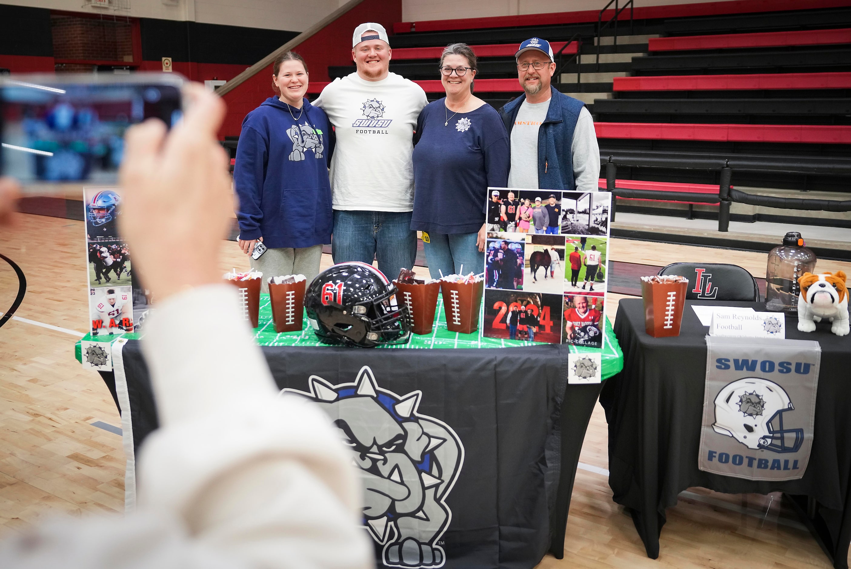 Lovejoy all-state offensive lineman Sam Reynolds poses for a photo with his family, from...