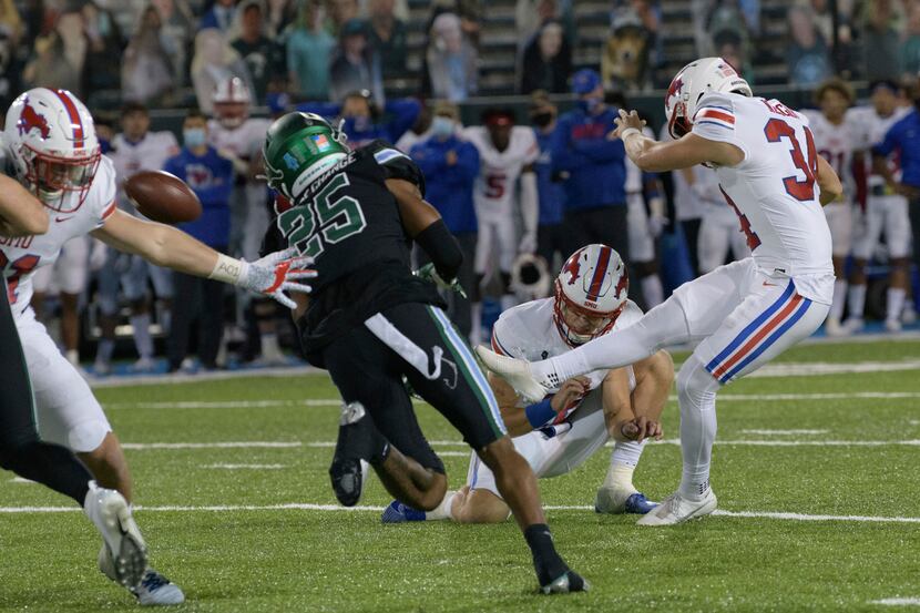 SMU place kicker Chris Naggar (34) kicks the winning field goal in overtime to give his team...