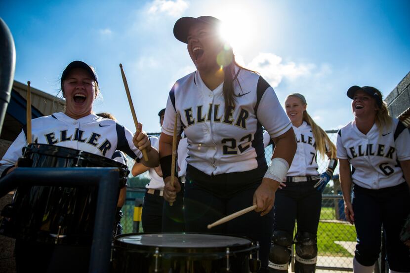 Keller's Dylann Kaderka (22, center) leads her team in a drum chant in the dugout during the...