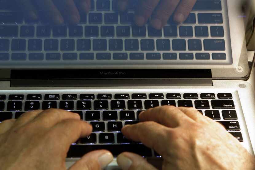 Hands type on a computer keyboard. Since the COVID-19 pandemic began, the FBI reports that...