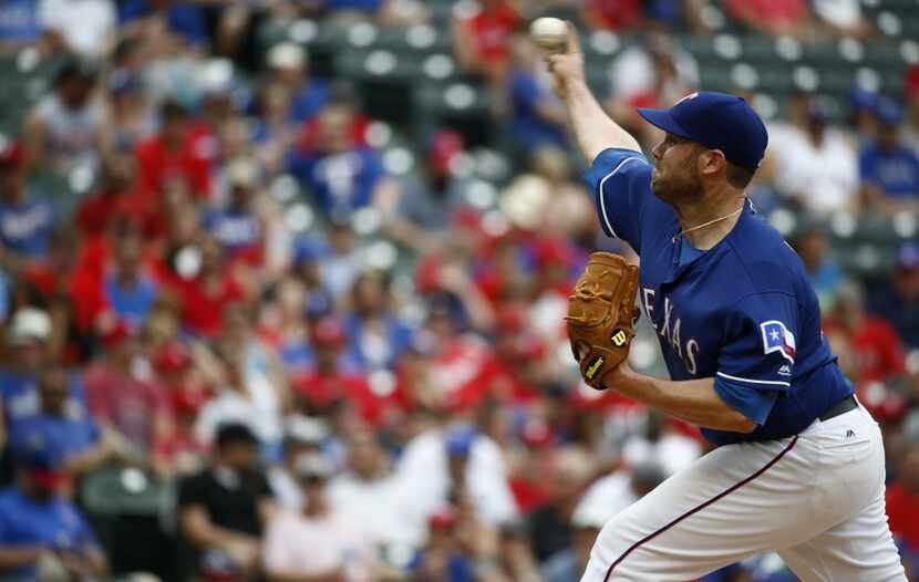 Texas Rangers starting pitcher Colby Lewis (48) pitches against Los Angeles Angels at Globe...