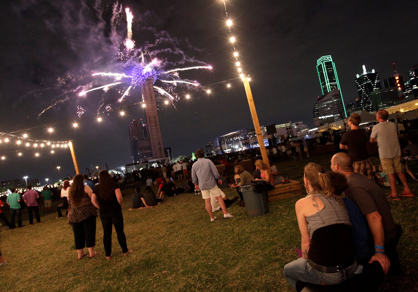 Festgoers watch the fireworks.