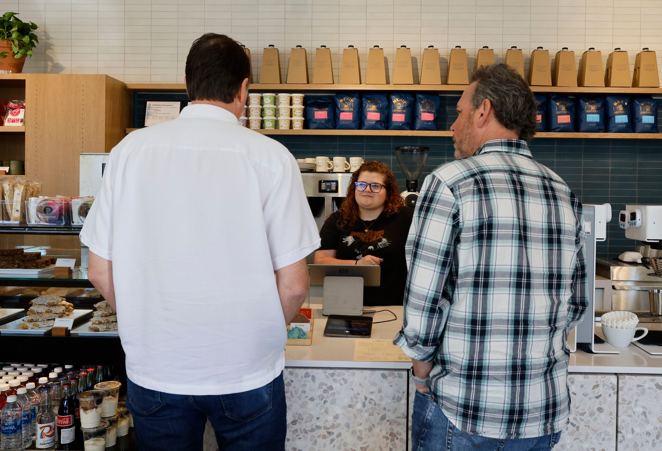 Summer Spalding, shift lead, center works during a soft opening of a new Merit Coffee shop...