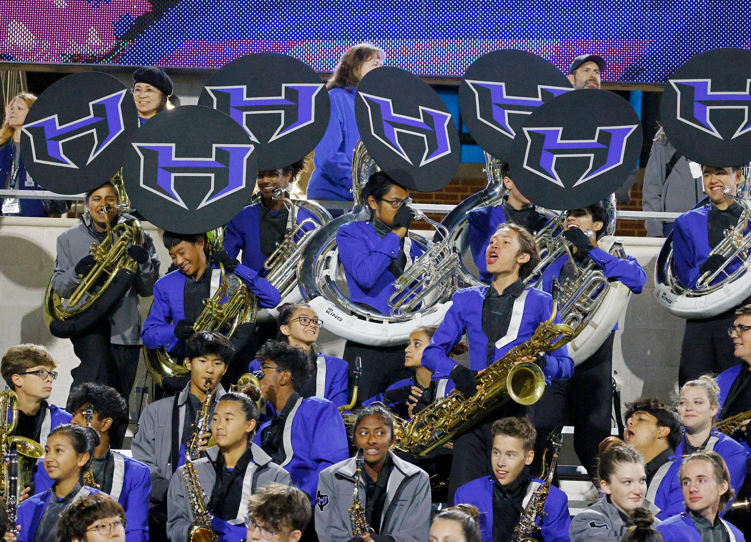 Hebron’s marching band members perform in the second half of a high school football game...