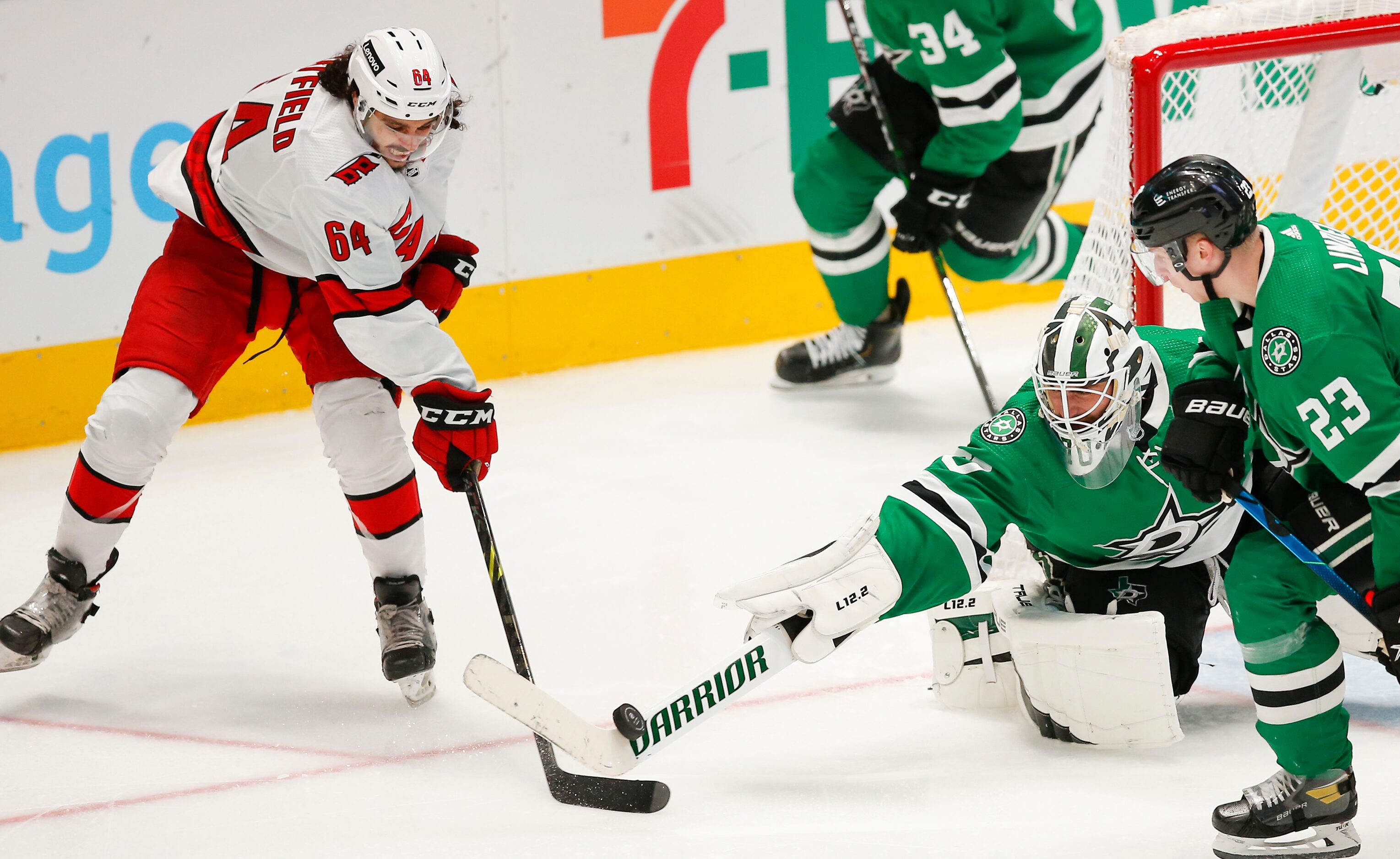 Dallas Stars goaltender Braden Holtby (70) bats the puck away from Carolina Hurricanes...