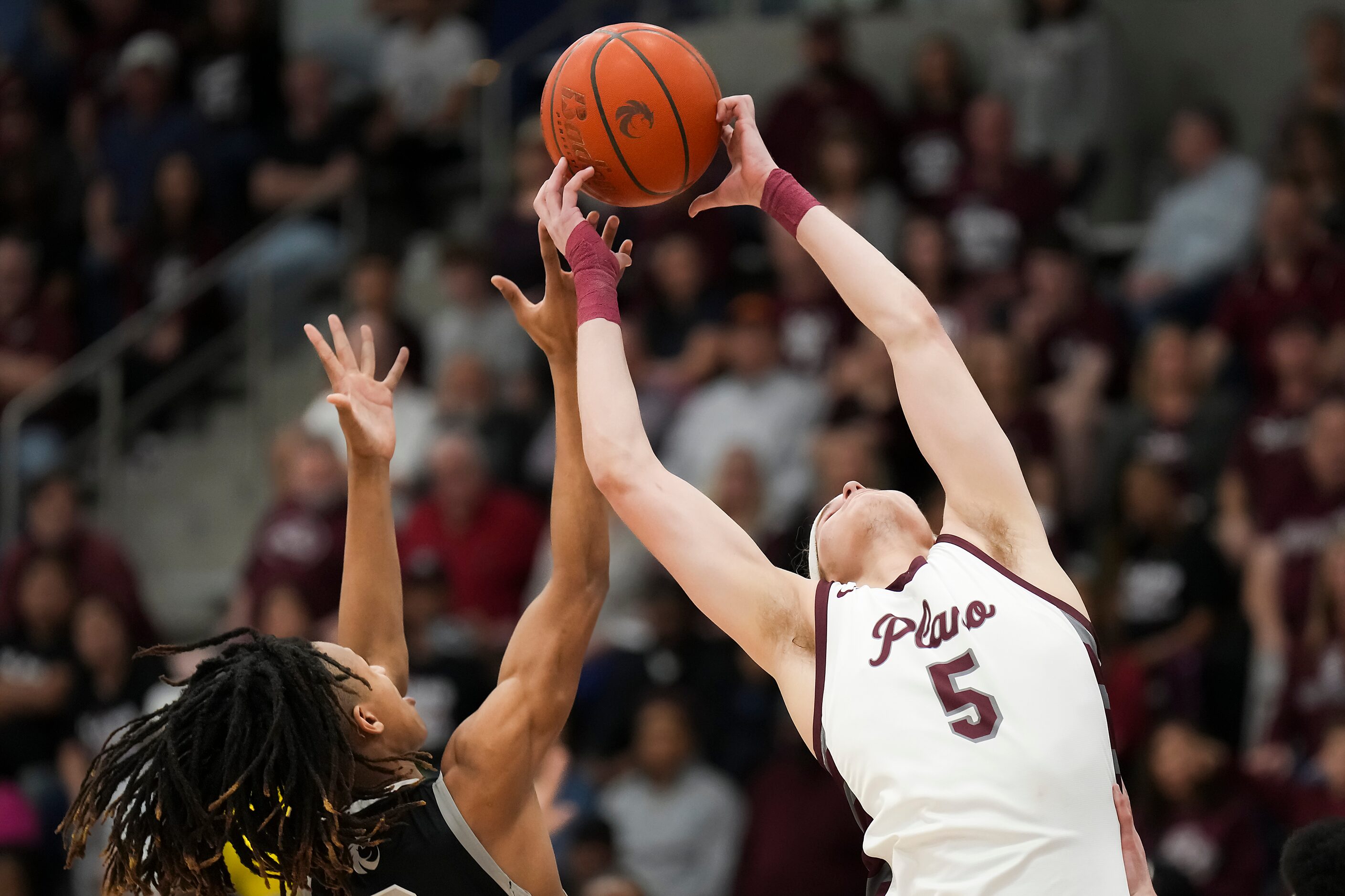 Plano forward Anes Kikic (5) grabs a rebound away from Denton Guyer forward Mason White...