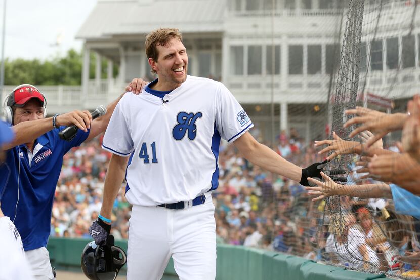 DIRK NOWITZKI , a star forward for the Mavericks, celebrated with fans after scoring a run...