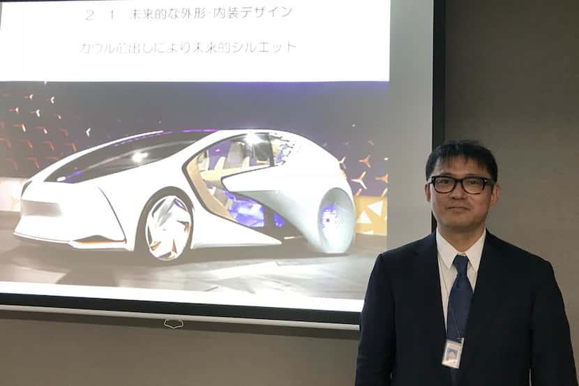 Toyota Motor Corp. manager Makoto Okabe stands in front of an image of the concept car...