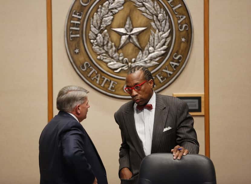 Commissioner Mike Cantrell (left) speaks with John Wiley Price, his colleague on the...
