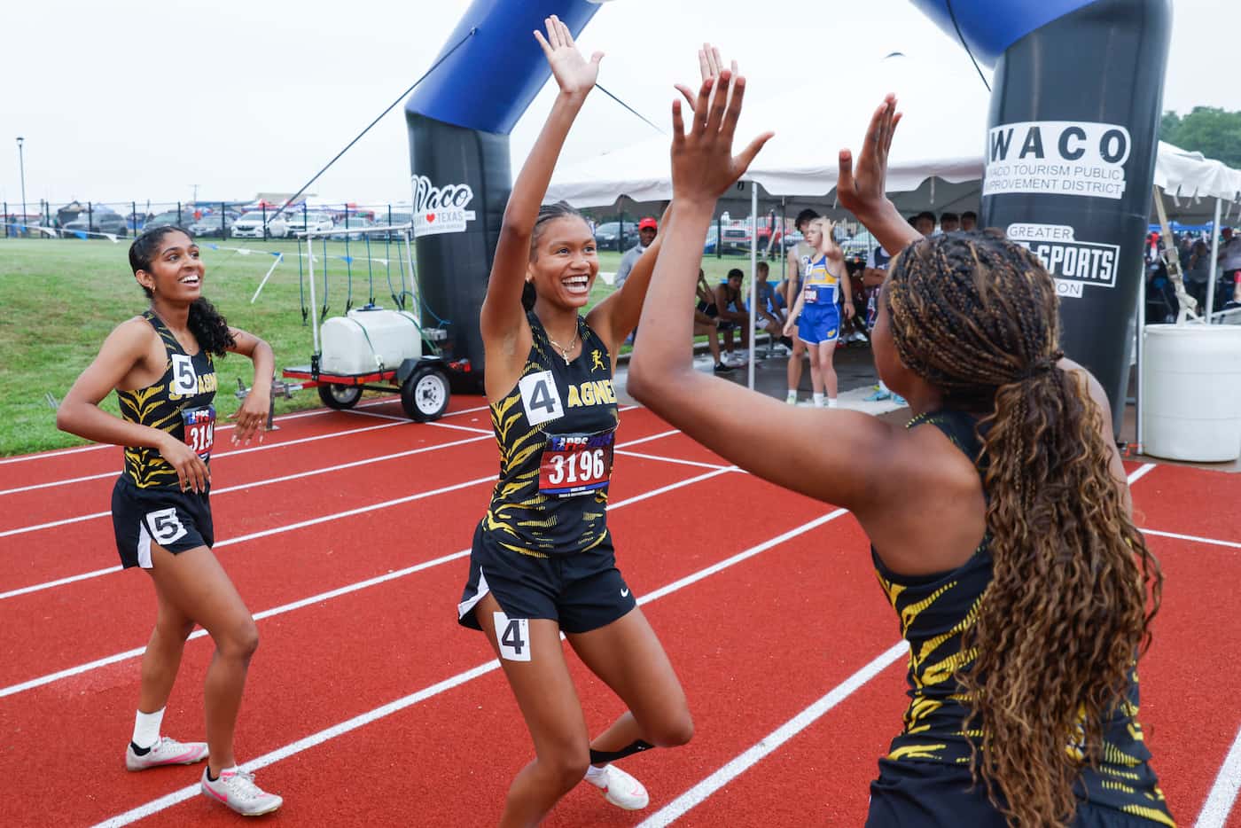 St. Agnes Academy runners cheer after taking the lead in women 100m hurdles 6A hurdle during...