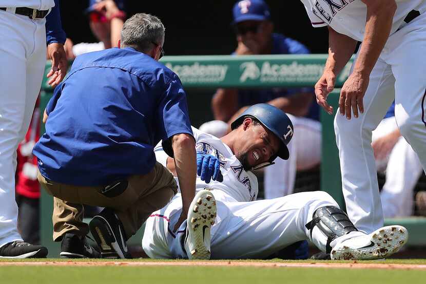 ARLINGTON, TX - SEPTEMBER 09:  Carlos Gomez #14 of the Texas Rangers winces in pain after...