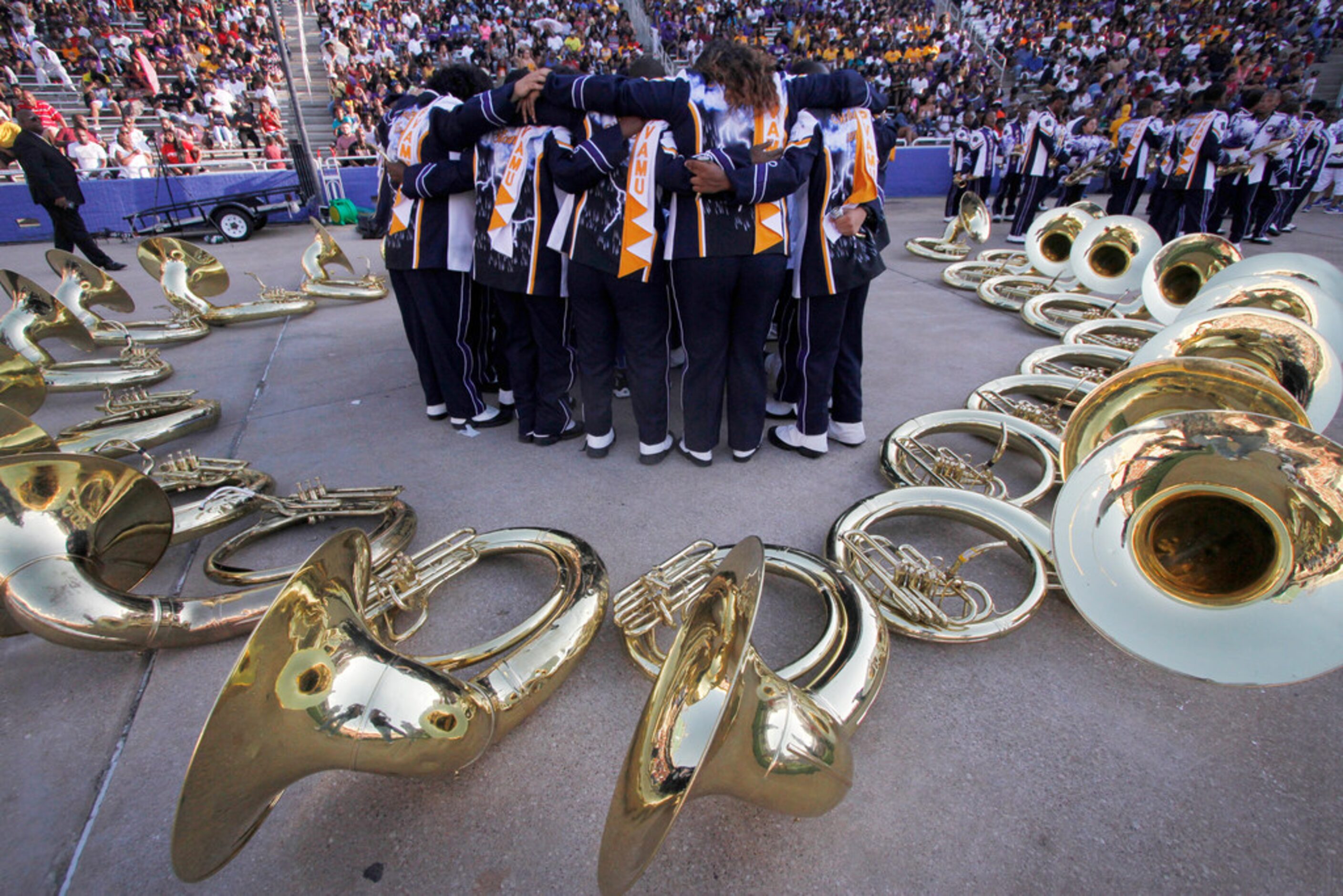 Part of the brass section of the Prairie View band pause and huddle before their performance...