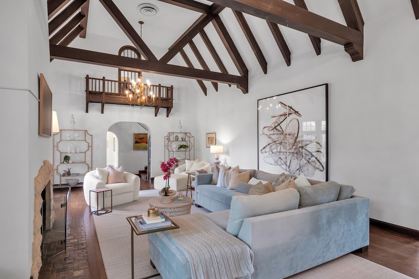 Another view of the great room shows the beams along the ceiling and a balcony-type spot on...