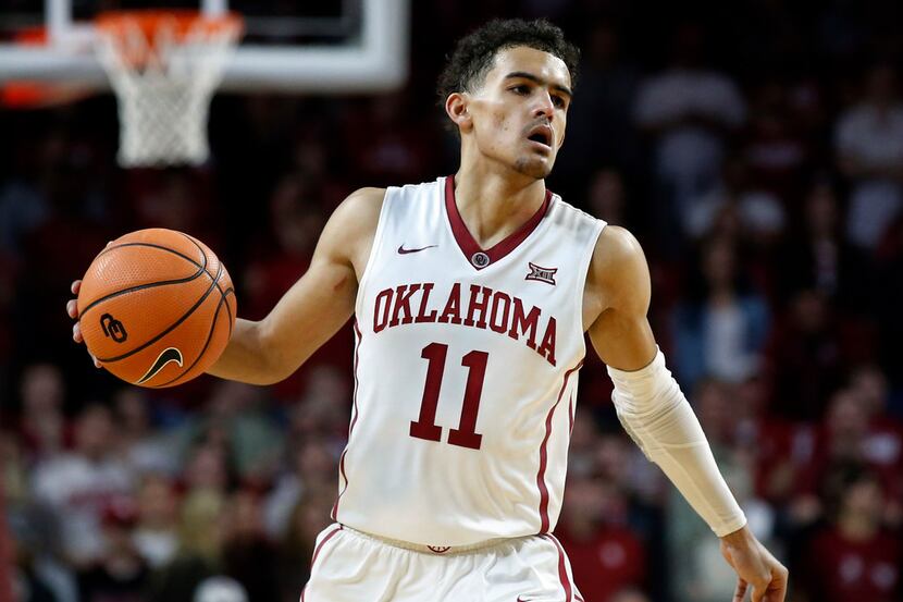 FILE - In this Feb. 17, 2018, file photo, Oklahoma guard Trae Young (11) brings the ball up...