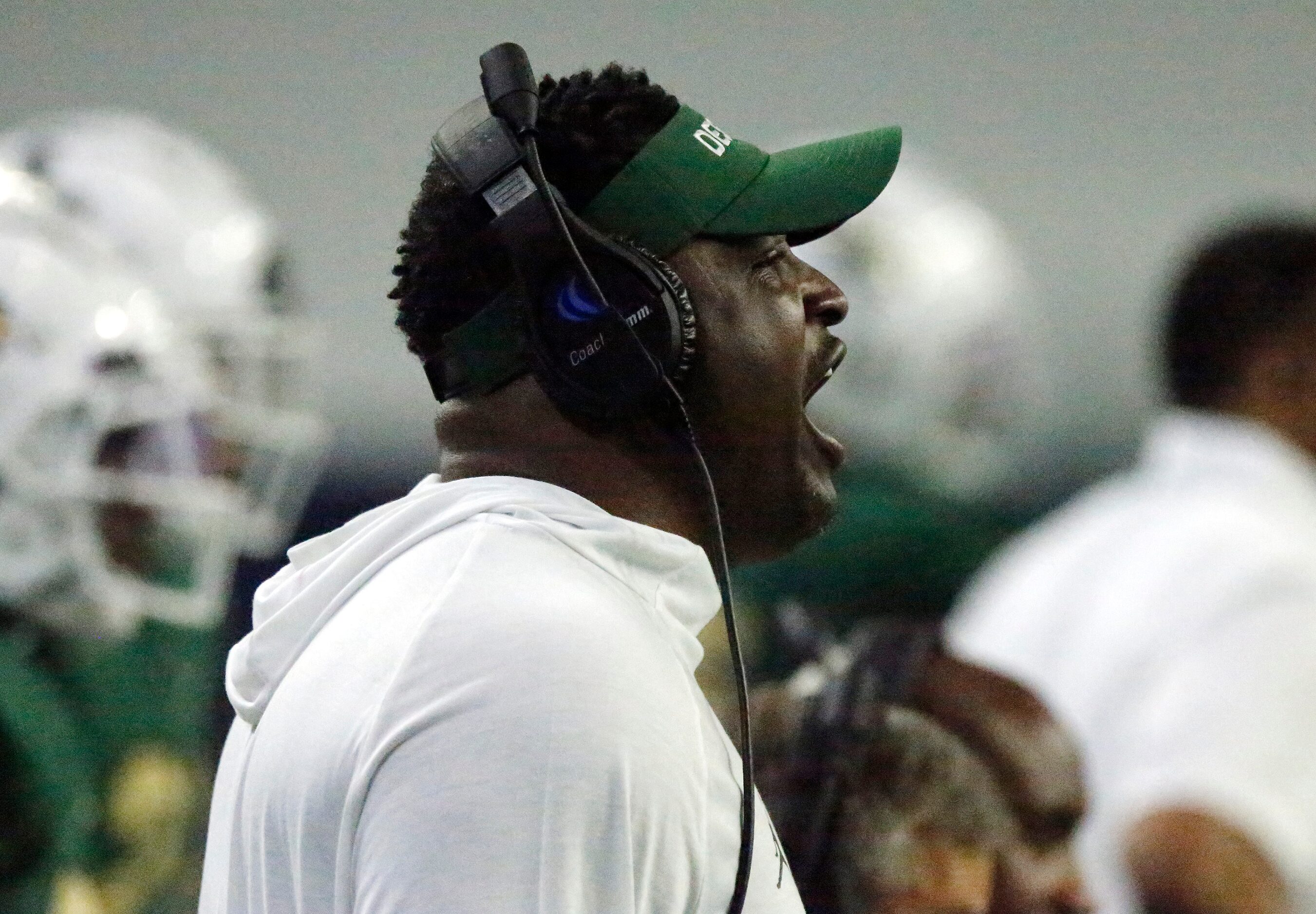 DeSoto High School head coach Claude Mathis shouts instruction during the first half as...