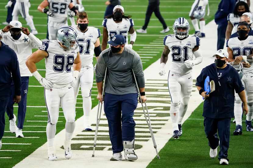 Dallas Cowboys offensive guard Zack Martin leaves the field on crutches after a 41-16 loss...