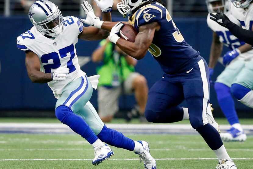 Dallas Cowboys cornerback Jourdan Lewis (27) avoids the stiff arm form Los Angeles Rams...