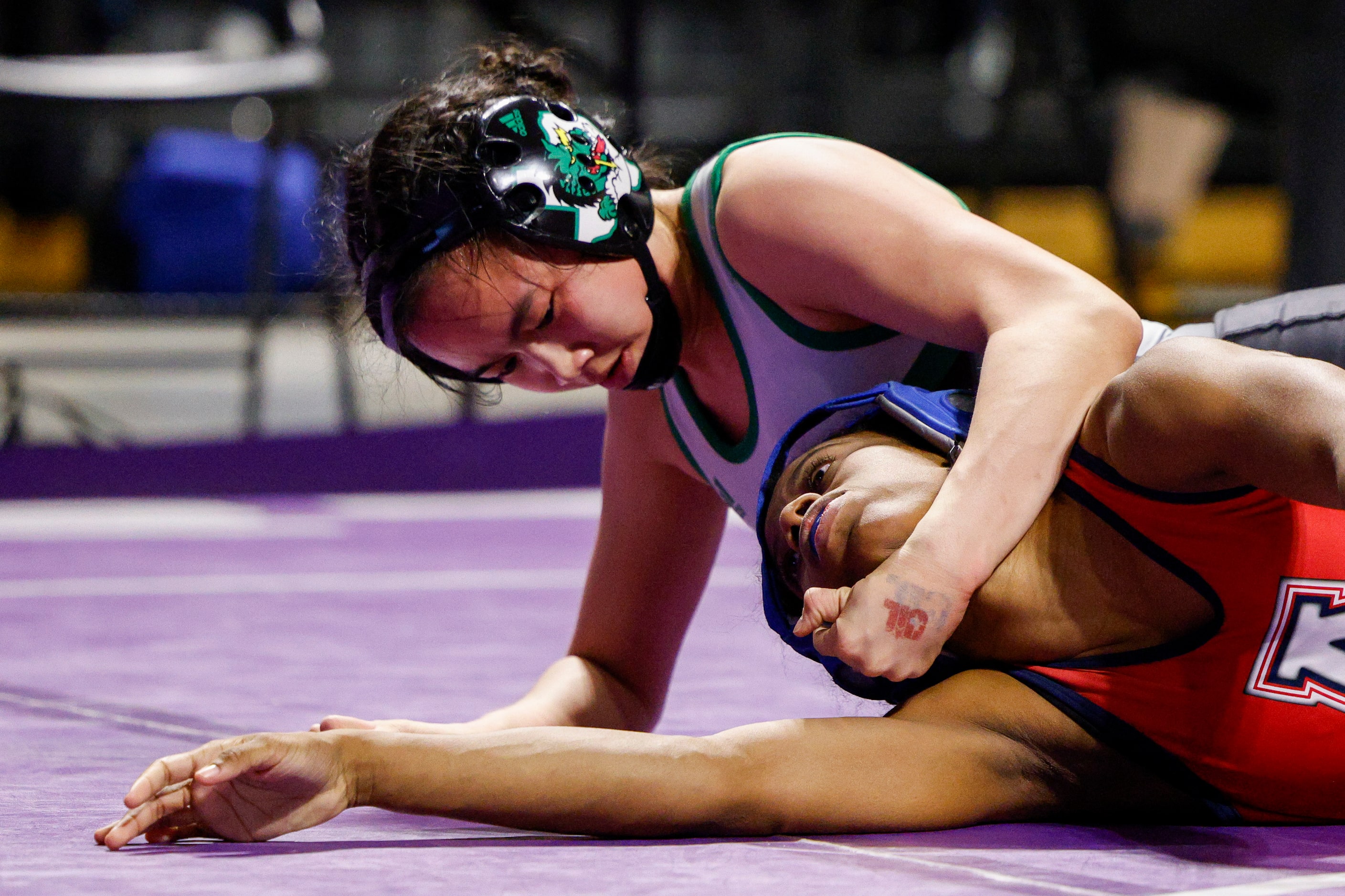 Bayley Trang of Southlake Carroll (left) wrestles Tabiah Walwyn-ton of Allen during the...