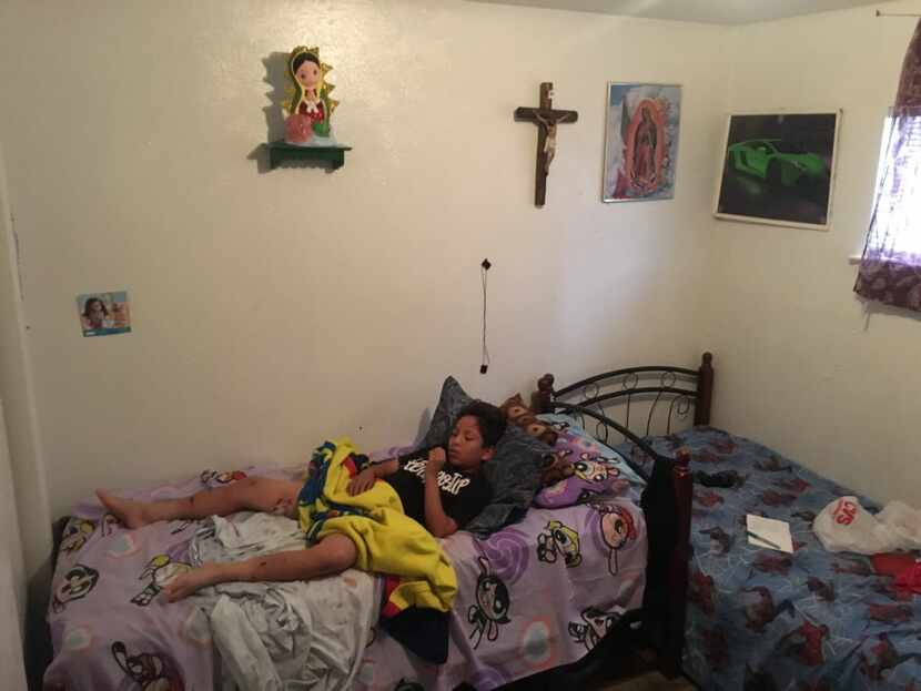 Jesus Galvan, 13, lay in his room in East Dallas on May 31, the day after he was attacked by...