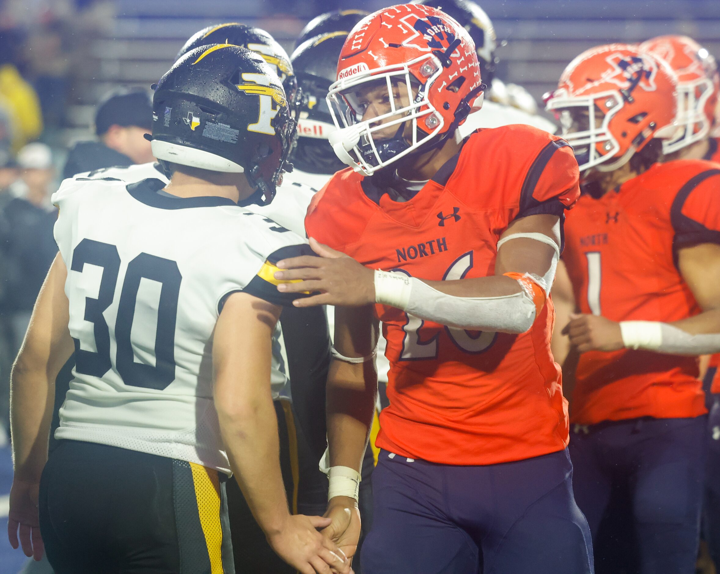 Forney line backer James Alms (30) shakes hands with McKinney North running back Jayden...