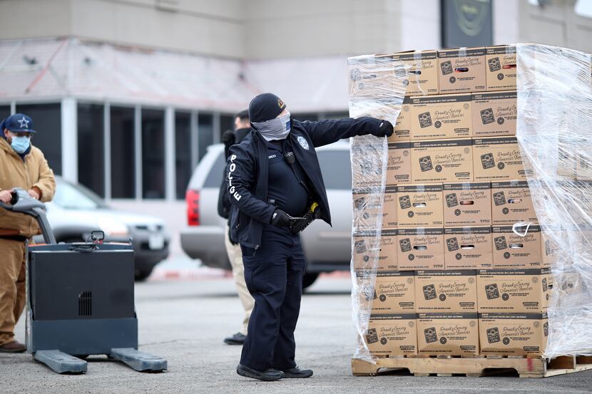 The Dallas Police Department distributes pallets of food to pantries in the Far West parking...